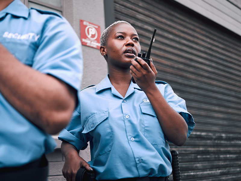 Female Security Guard Using Walkie Talkie - Security Courses Australia
